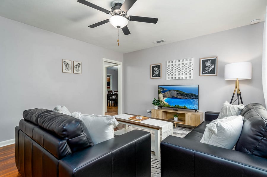 Living Room: Long black couch with 50" tv.