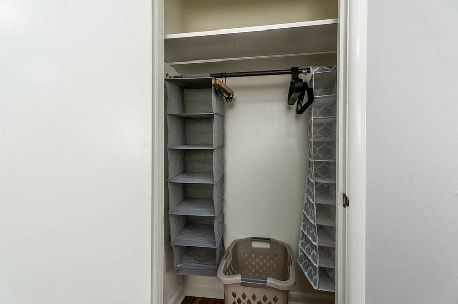 Storage closet with hangers.