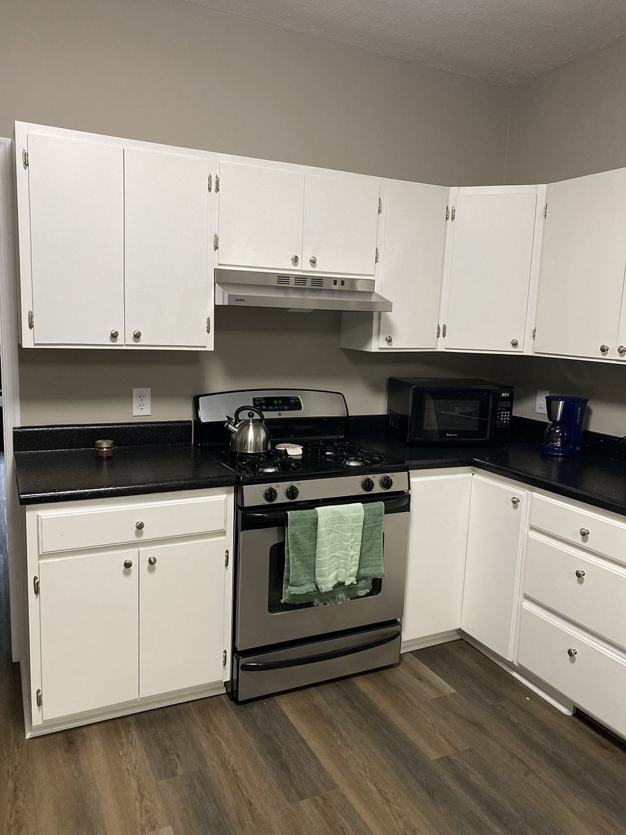 Full kitchen with coffee maker, tea kettle, pots and pans, dish machine, plates cups and utensils