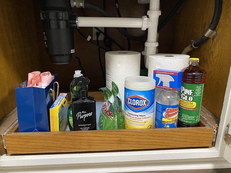 Under kitchen sink, cleaning supplies