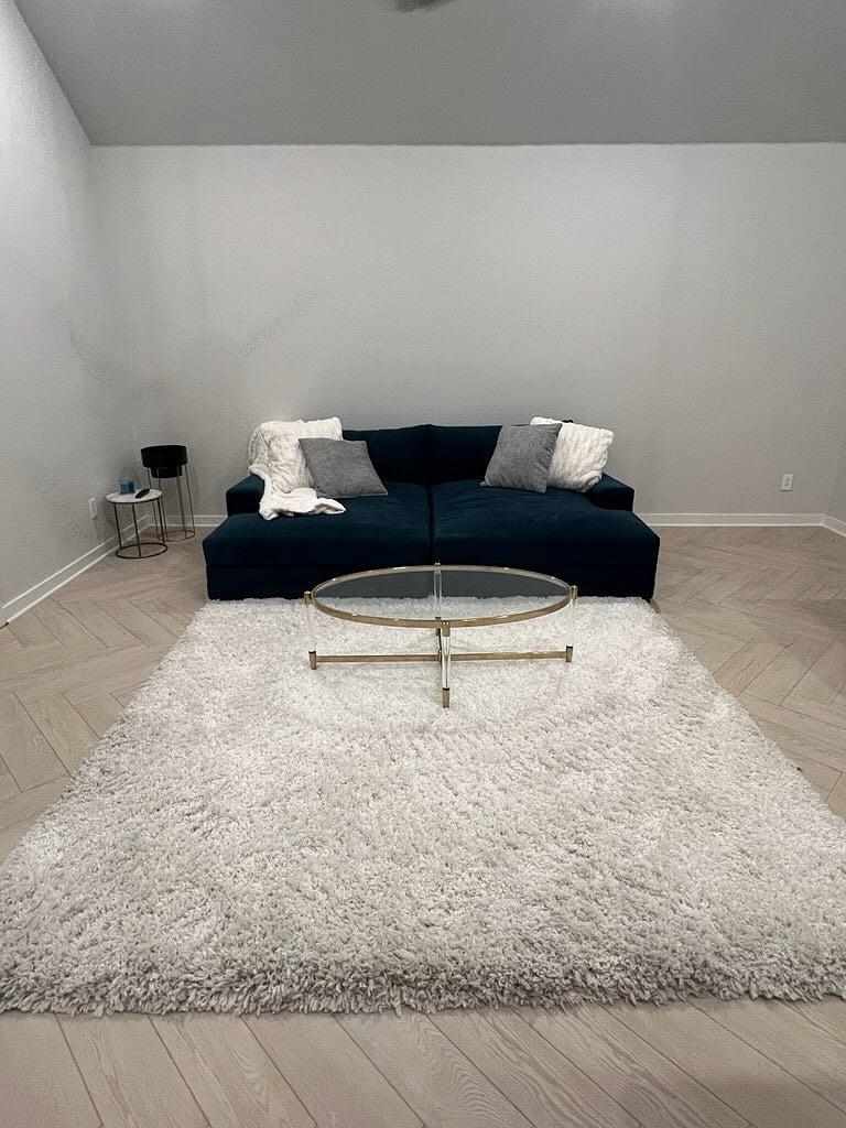 Upstairs living space. Plush lounging couch. Can be pulled apart for two large chaise chairs or put together like in the photo for additional sleeping space or lounging for tv/movies.