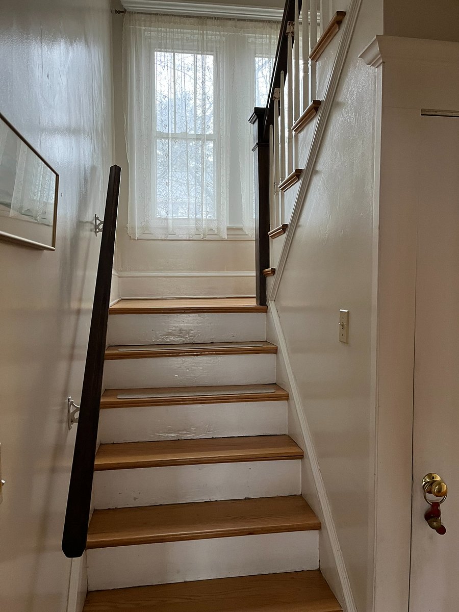 stairs to 2nd level of house, where bedroom and full bath are located