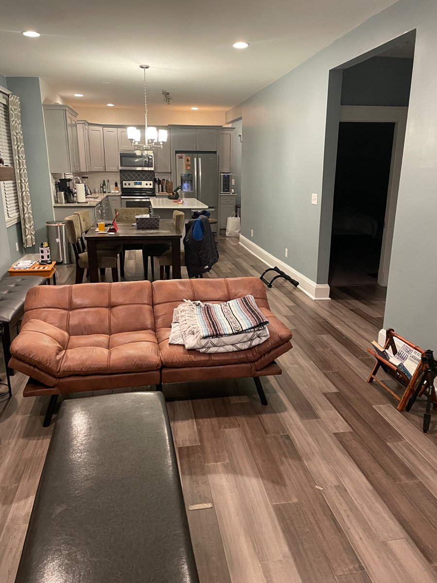Living room, dining table, and kitchen at far end with island