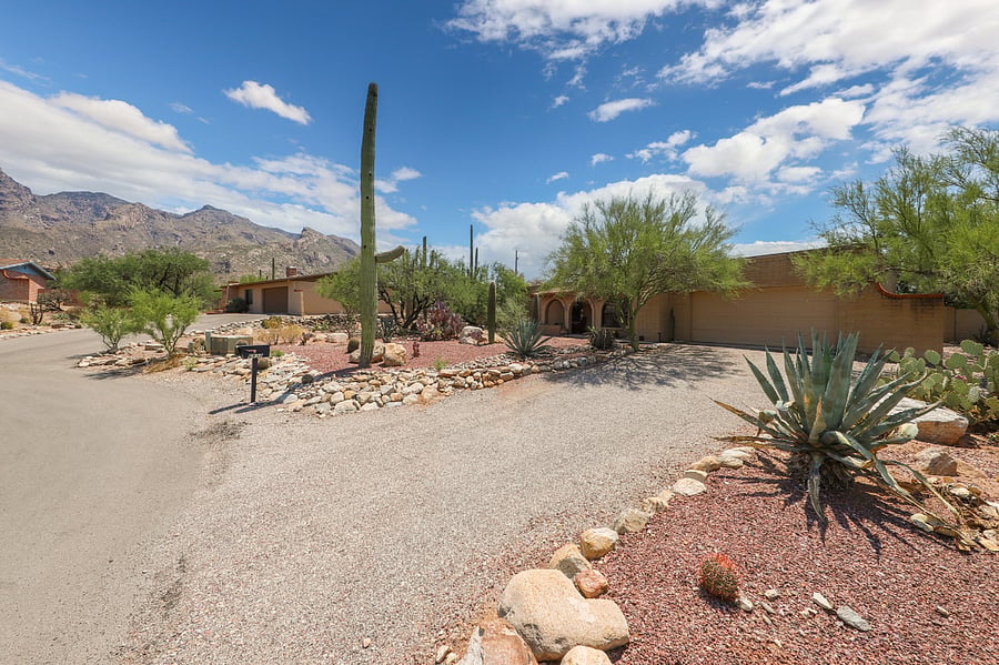Front of home with mountains behind