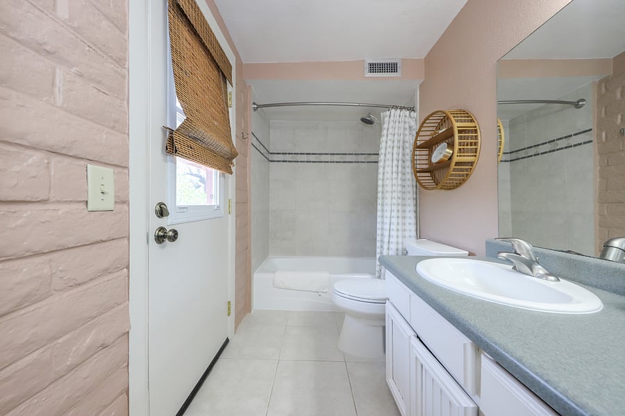 Primary Bathroom ensuite with full bathtub and shower. Access to backyard/pool