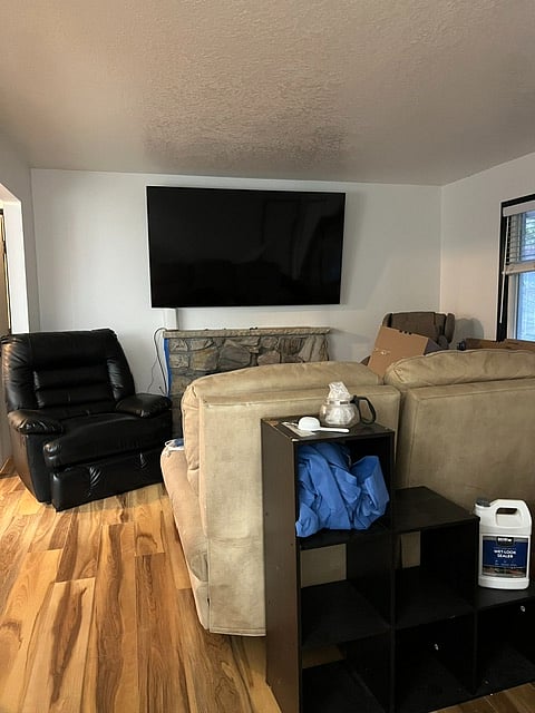 Living room with fireplace and a large vibrating chair in the corner