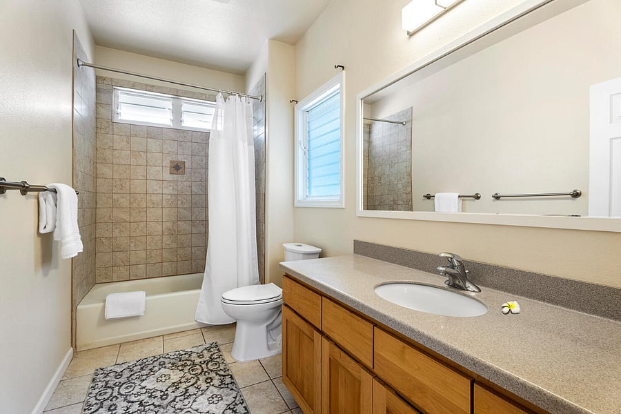 Bathroom #1 features a wide vanity and combination tub/shower
