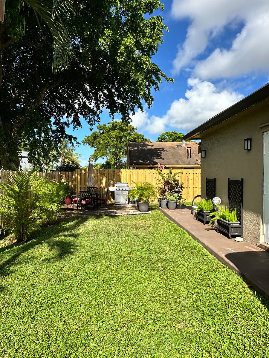 Back yard with outdoor dining and grill 
