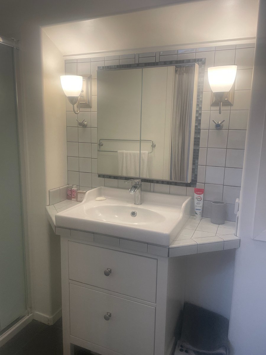 Bathroom with and tankless, on-demand water heater.