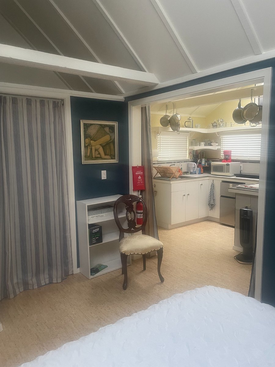 Fully equipped kitchen with small refrigerator, microwave and conventional ovens, and an induction stove with 2 burners