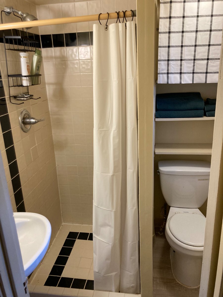 Tiny bathroom comes stocked with towels and starter toiletries.