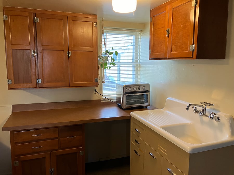 The kitchenette features a convection/toaster oven and a farmhouse sink.