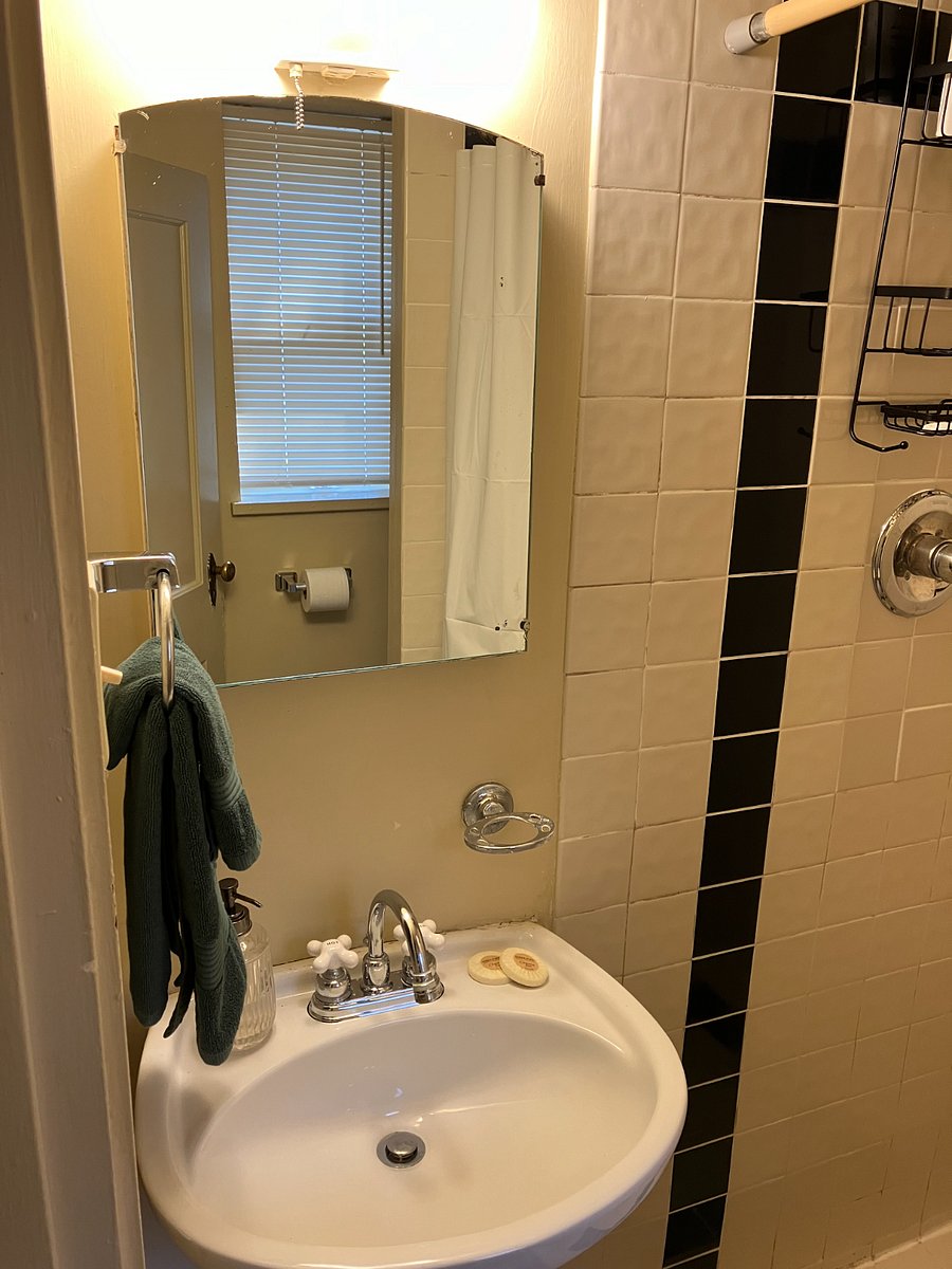 Tiny bathroom comes stocked with towels and starter toiletries.