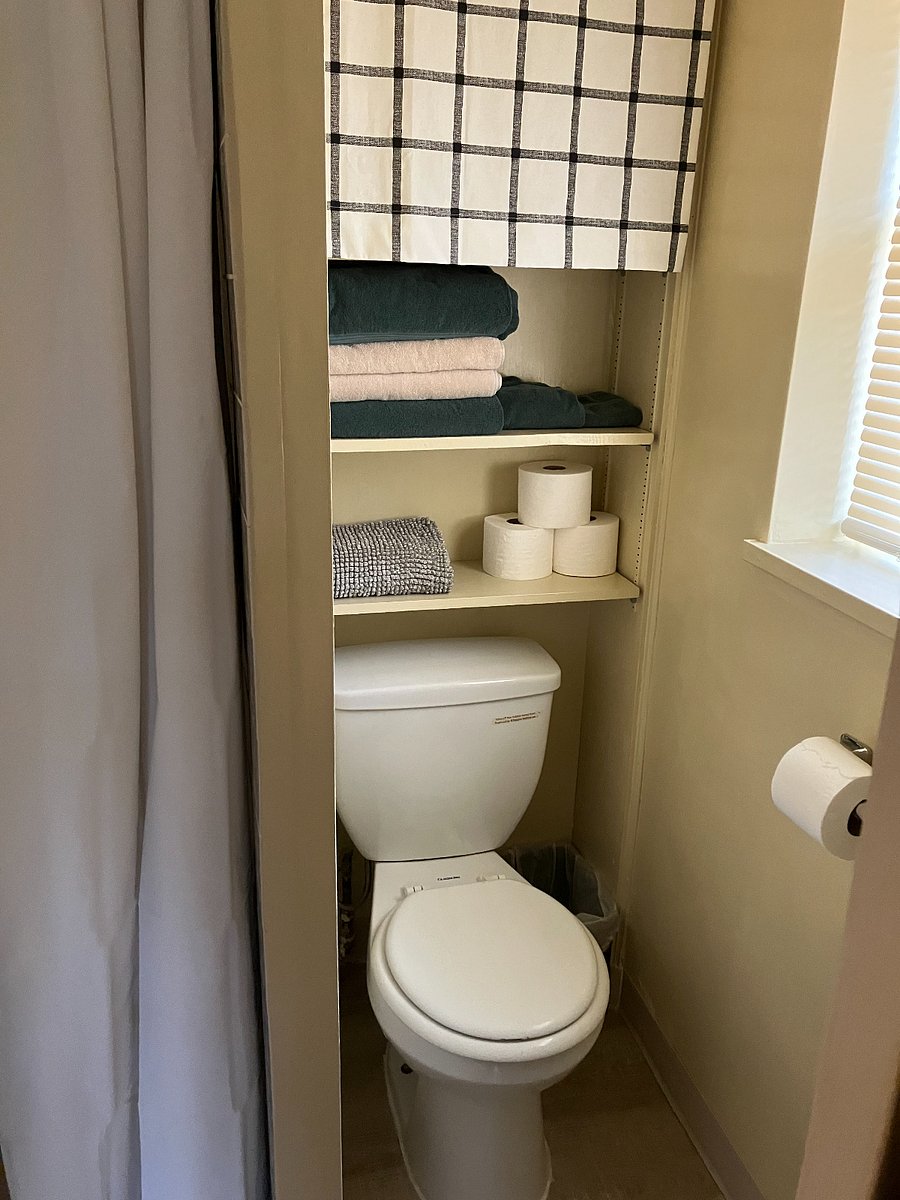 Tiny bathroom comes stocked with towels and starter toiletries.