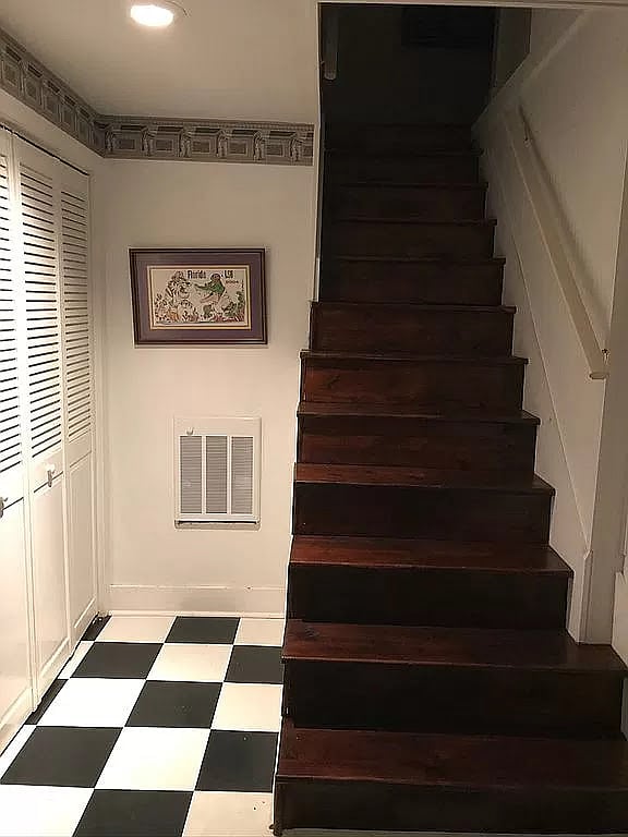 Stairs to apartment from front door. Washer & dryer behind the louver doors.