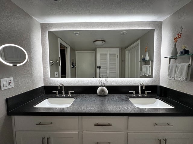 Dual sinks with ample storage and drawers. Custom backlit LED mirror and SimpleHuman sensor mirror