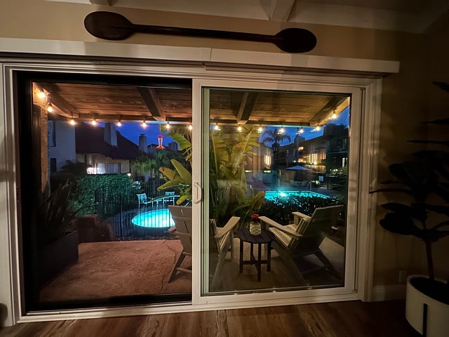 Patio with view of the jacuzzi / pool. There is a large bird of paradise tree that offers some privacy.