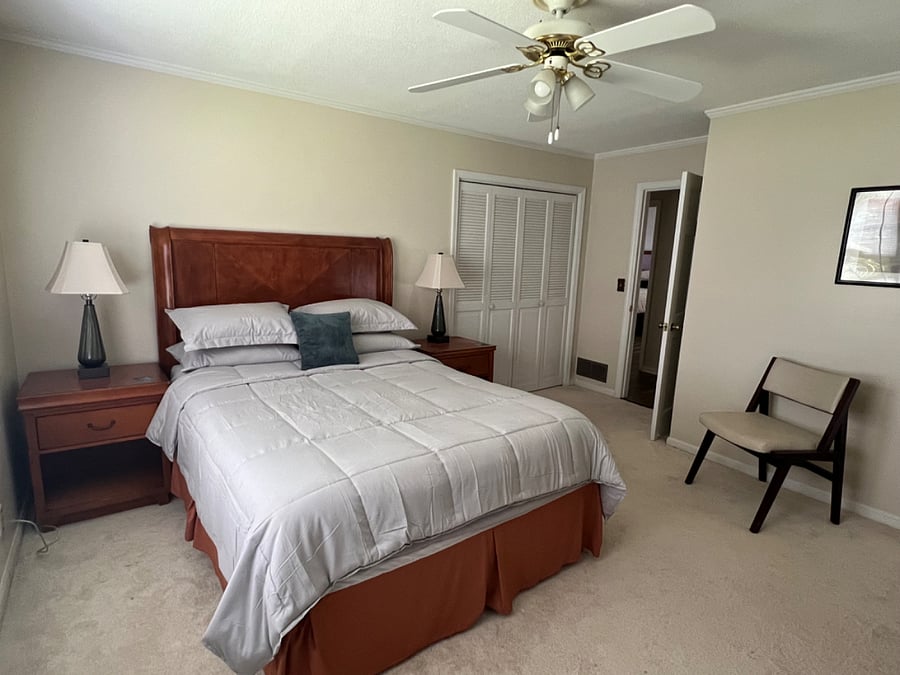 Bedroom 2- large bedroom with queen pillow top bed, 2 closets, 2 nightstands, 2 windows, dresser and chair