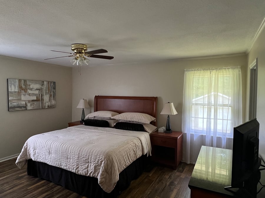 Bedroom 1-luxury primary suite with pillow top king bed, 2 nightstands large windows
