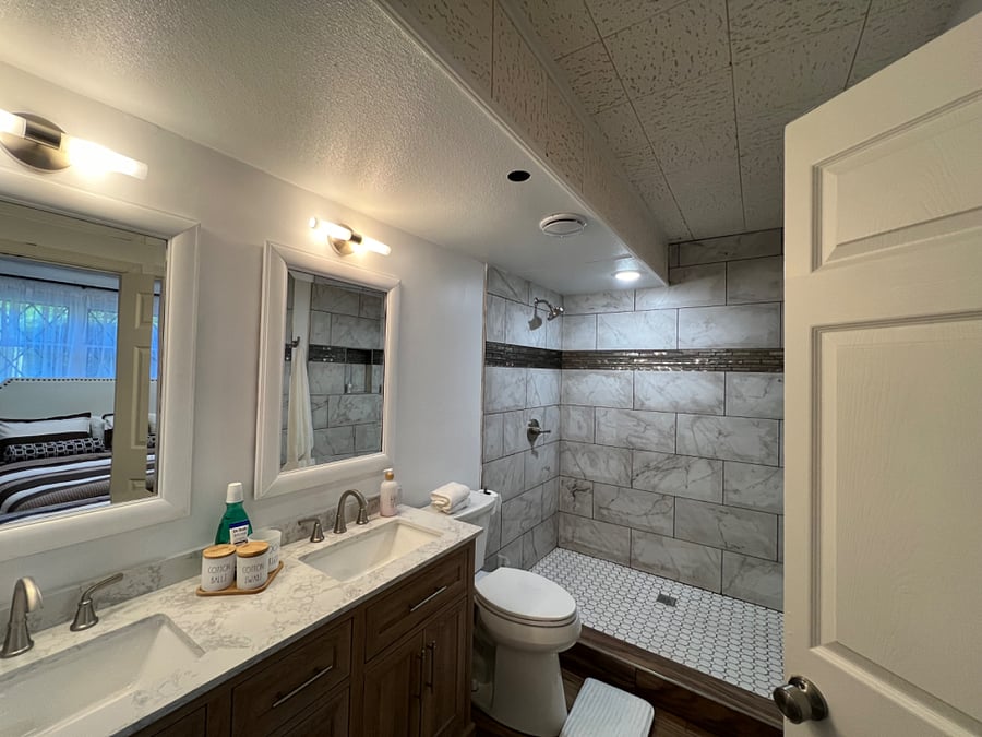 Start and end your day in this spa like bathroom! 5 double sinks w/stone top, drawer storage wood vanity, 6x 3.5shower, comfort height toilet 