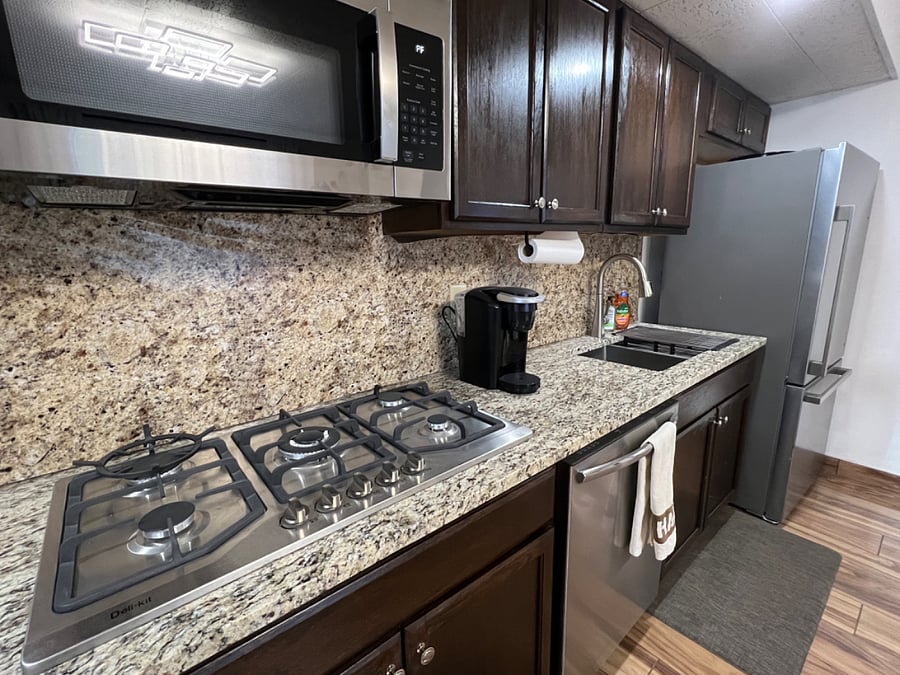 New stone countertops and full size stainless steel appliances 