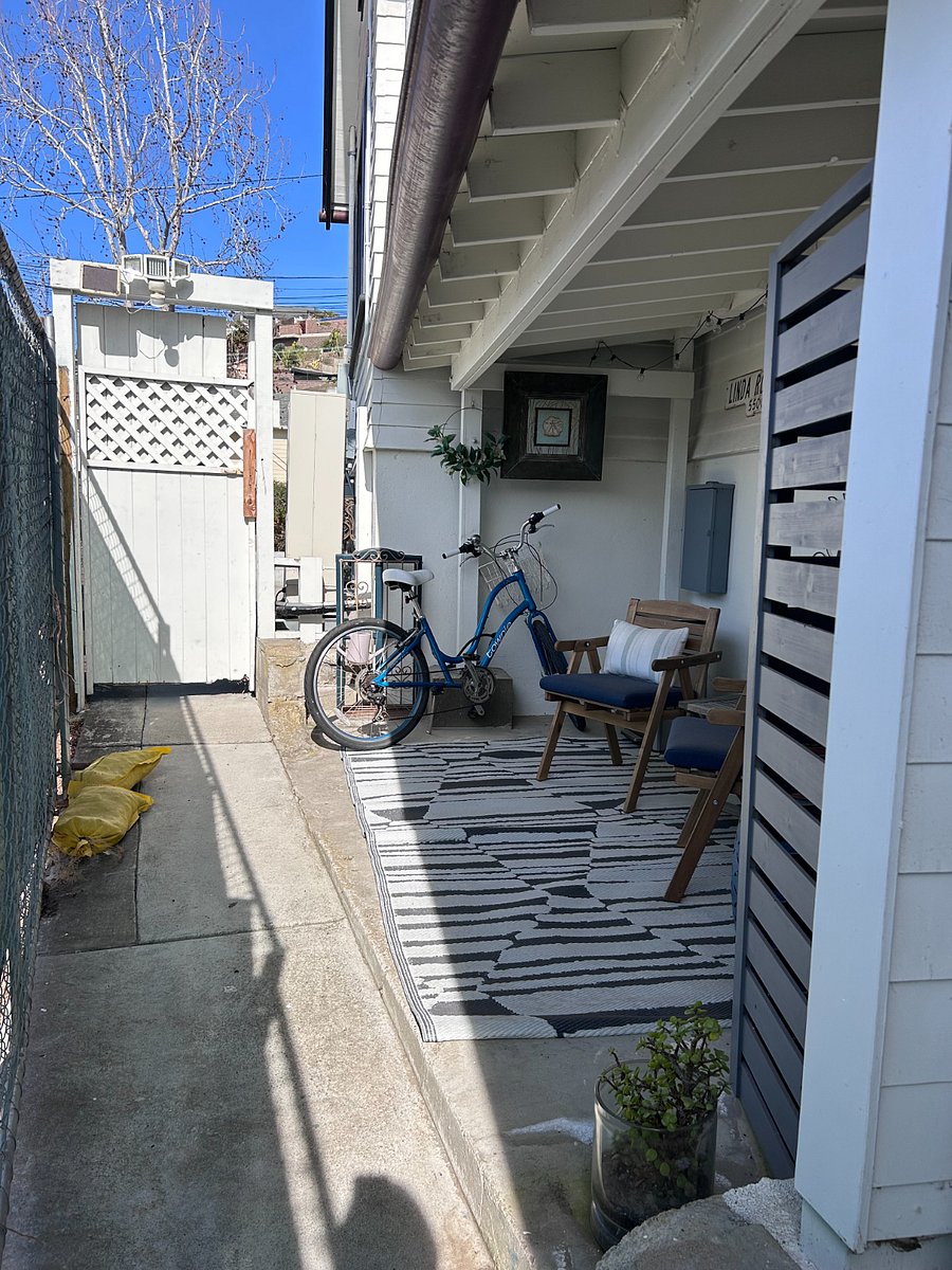 exterior sitting area with twinkle lights and a bike to ride