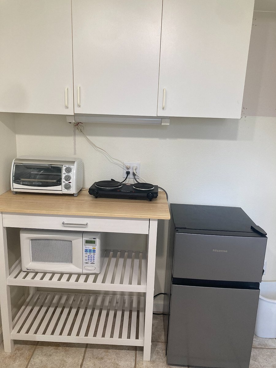 Kitchenette includes everything you could need to prepare and serve a meal (except a full size oven). The cabinets above hold your dishes etc, and have extra space for your dry food storage. The fridge is a bit larger than you typical mini fridge. 