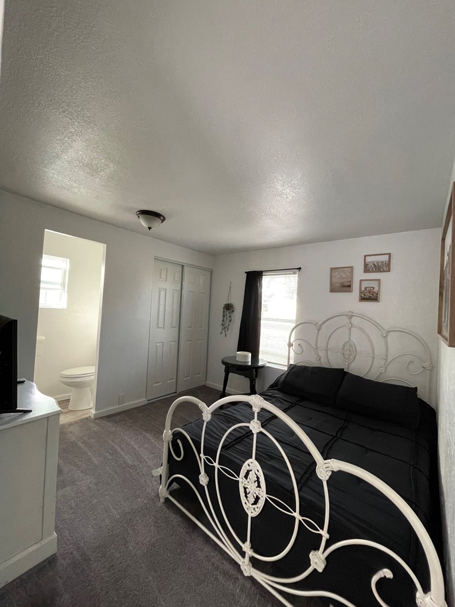 Master bedroom with 1/2 bathroom and queen bed