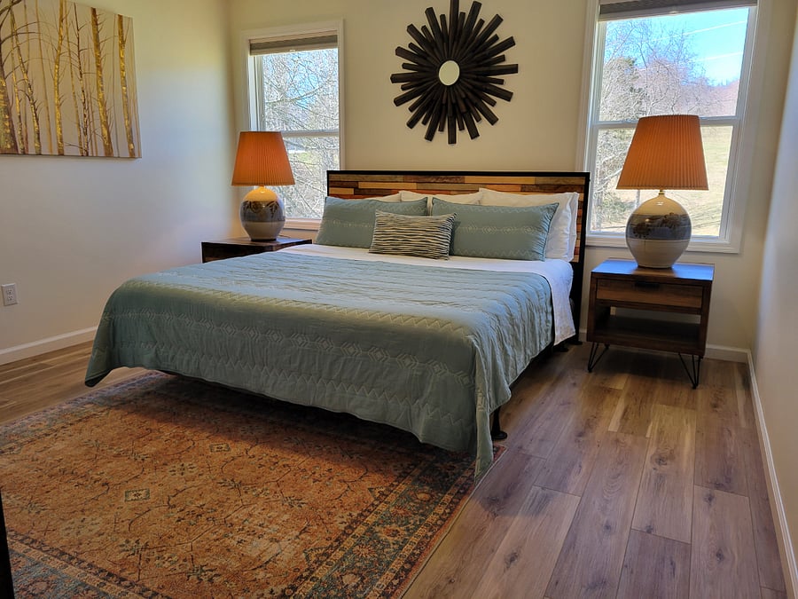 Spacious bedroom with king bed and blackout blinds. 