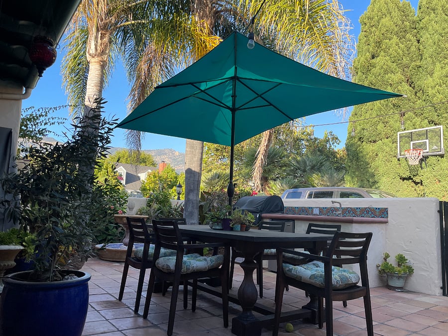 Shared courtyard with dining space, seating space, lighting and fountain.