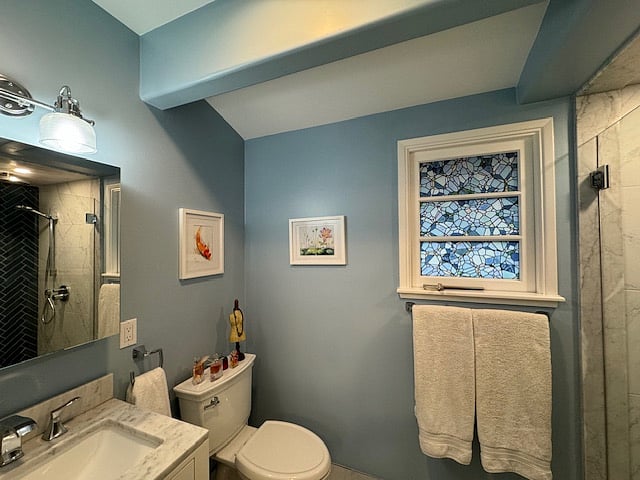 Bathroom with shower regular and rain showerheads (no bathtub).