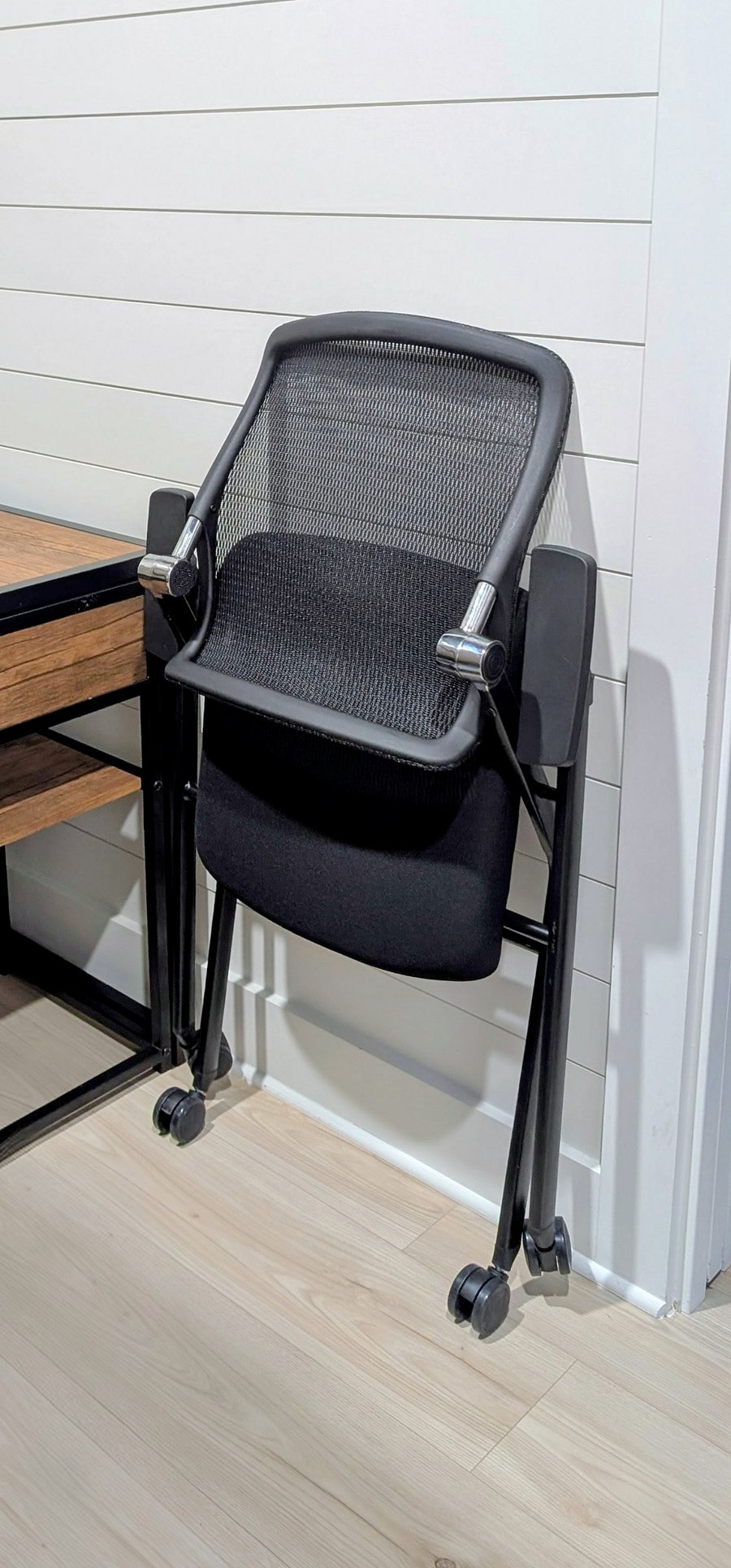 Office chair folds up and has a dedicated spot when not in use