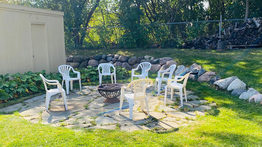 Backyard patio with fire pit. Firewood is provided.