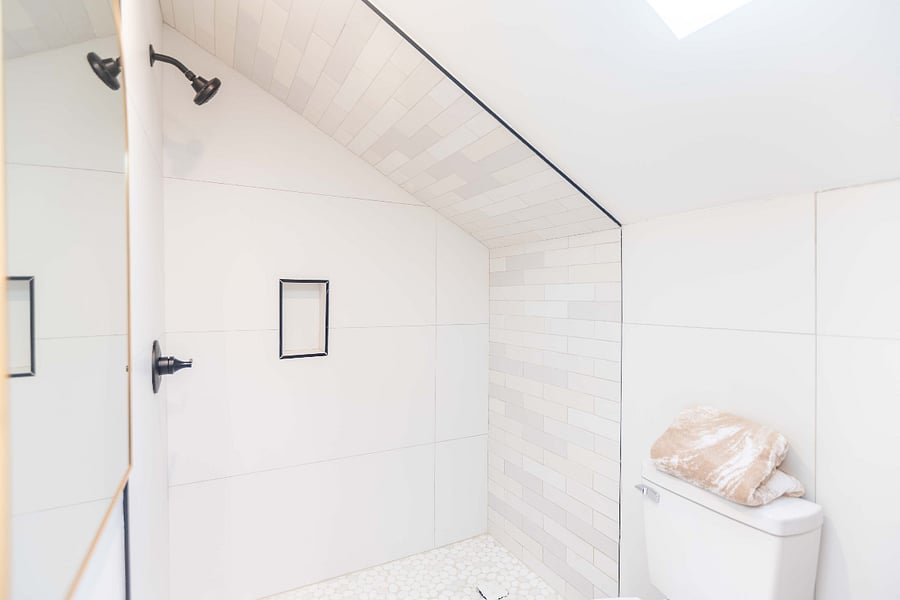 Ensuite private bathroom with large gold trim mirror, porcelain surround