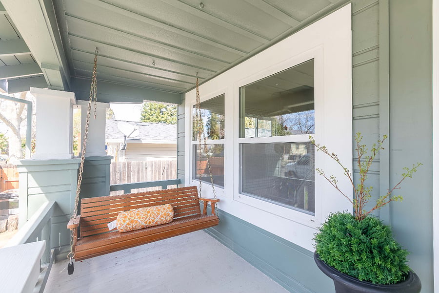 Swing on both side of front porch. Tranquil street lined with houses of previous century