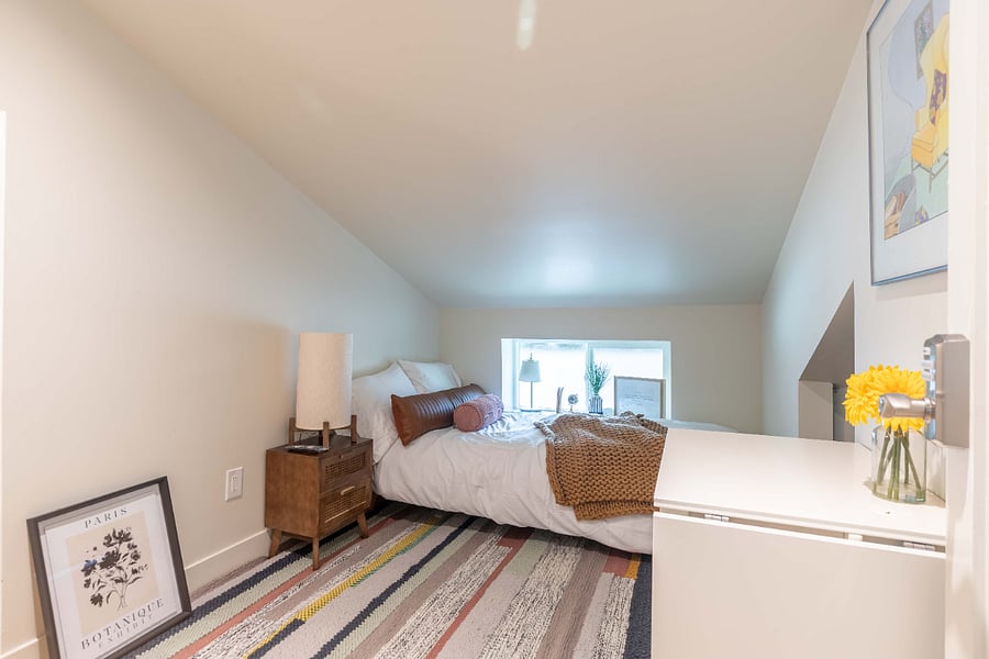 95 sf (10'x9.5'). Slope ceiling only suitable for under 5'6" person.