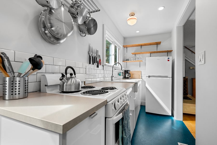 Well-stocked kitchen with range and refridgerator