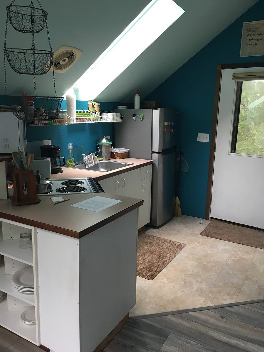 Kitchen with range, frig, microwave, toaster, coffee pot, dishes, cookware, etc. (see next photo for new flooring).
