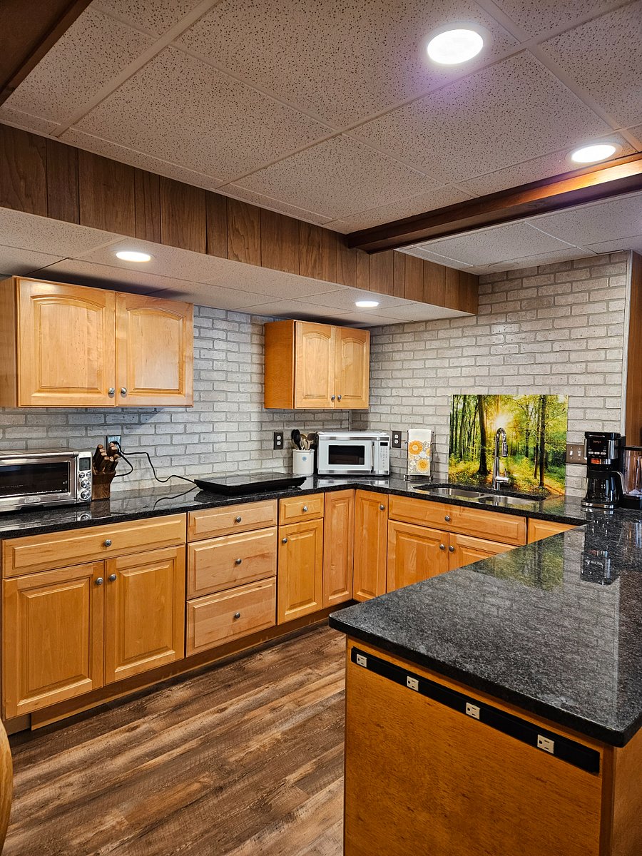 Updated kitchen with beautiful counters and lots of storage.  Large toaster oven, microwave, two-burner cooktop, dual single-serve and pot coffee maker.  Plus extra countertop appliances for cooking ease.