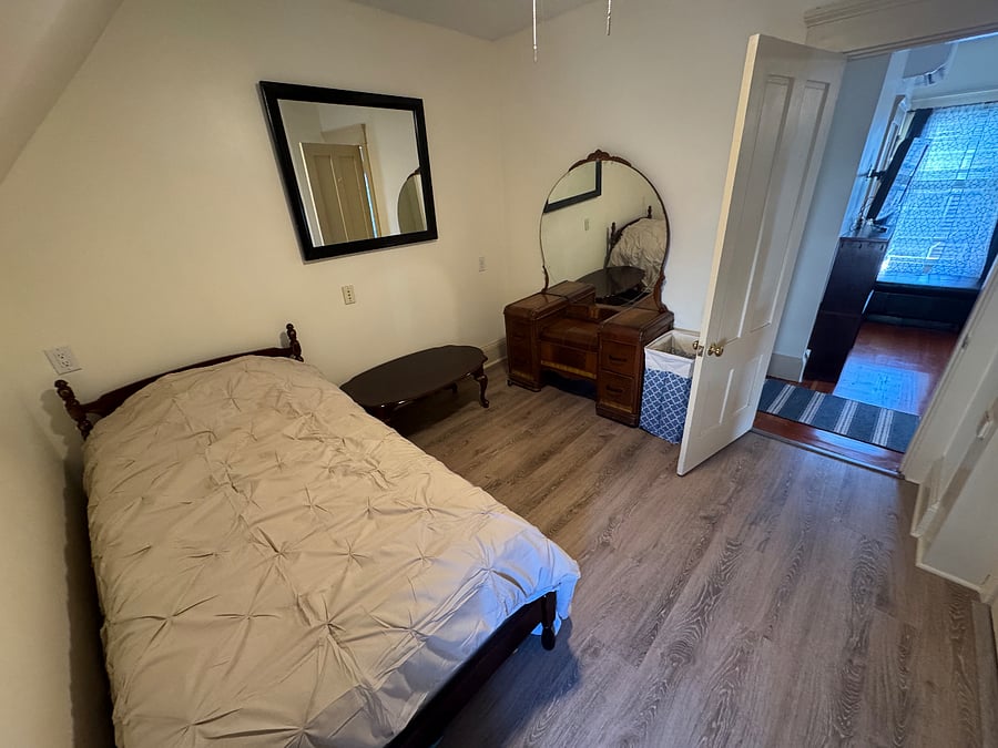 small twin bedroom with office desk