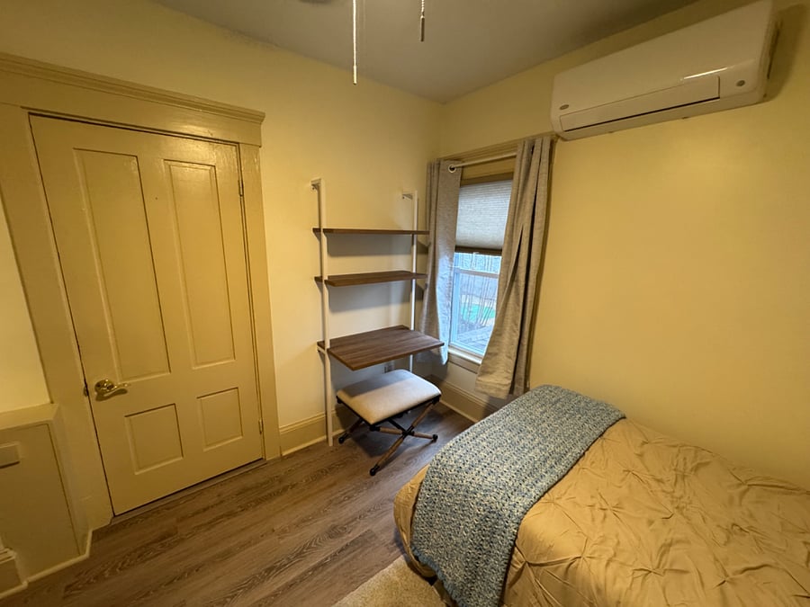 small twin bedroom with office desk