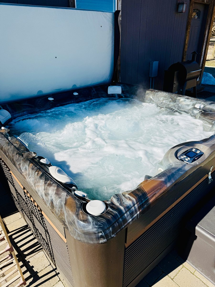 New oversized saltwater hot tub in backyard