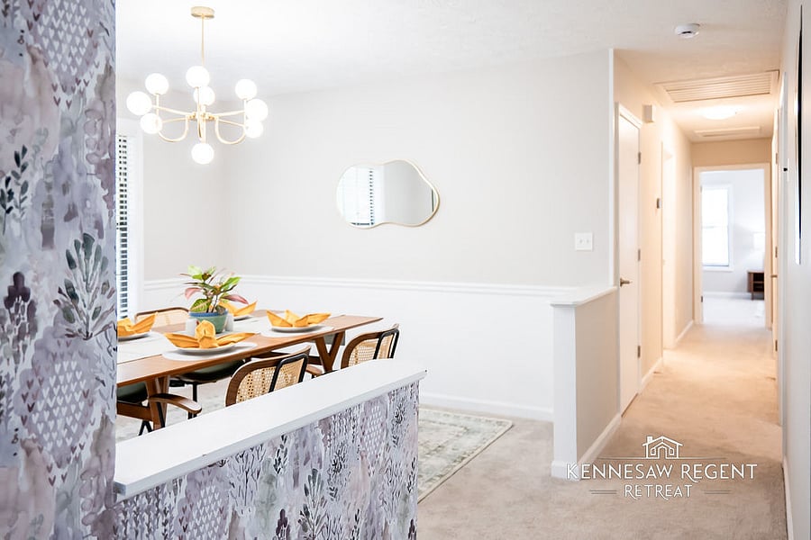 The open and welcoming dining room has been recently renovated with a stunning West Elm dining set, custom artwork, and personal touches, adding a touch of elegance and warmth to the home.