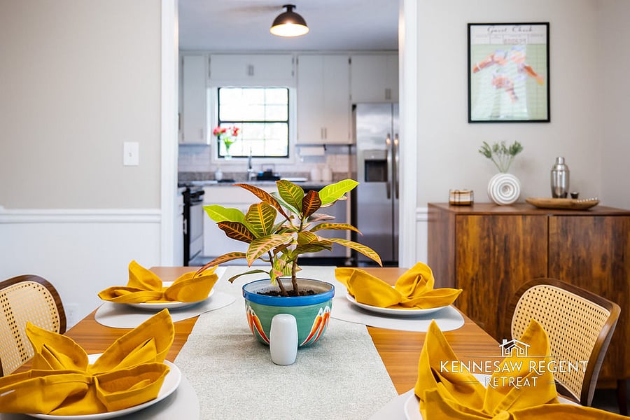 The open and welcoming dining room has been recently renovated with a stunning West Elm dining set, custom artwork, and personal touches, adding a touch of elegance and warmth to the home.