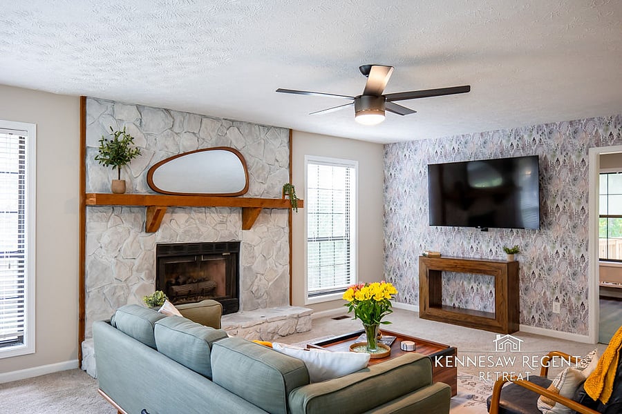 This newly remodeled space is bathed in natural light and features a stylish fireplace and a 65" smart TV. High-quality furnishings complete the elegant and functional living area.