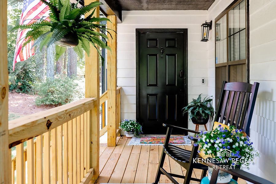 A charming front porch, complete with a cozy seating area, invites you to enjoy your morning coffee and greet friendly neighbors. The perfect spot to relax and soak up the atmosphere.