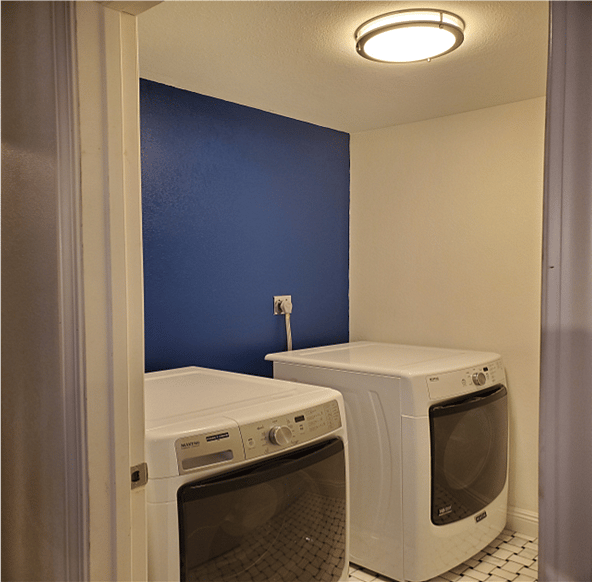 Separate laundry room has high capacity washer and dryer.