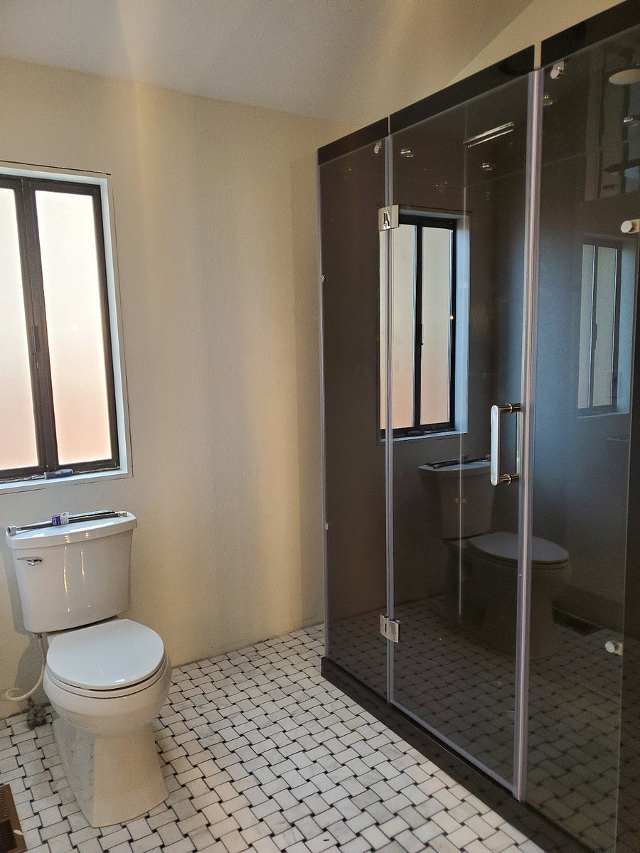 Steam shower in master bath has both a rain forest and hand held showerheads.