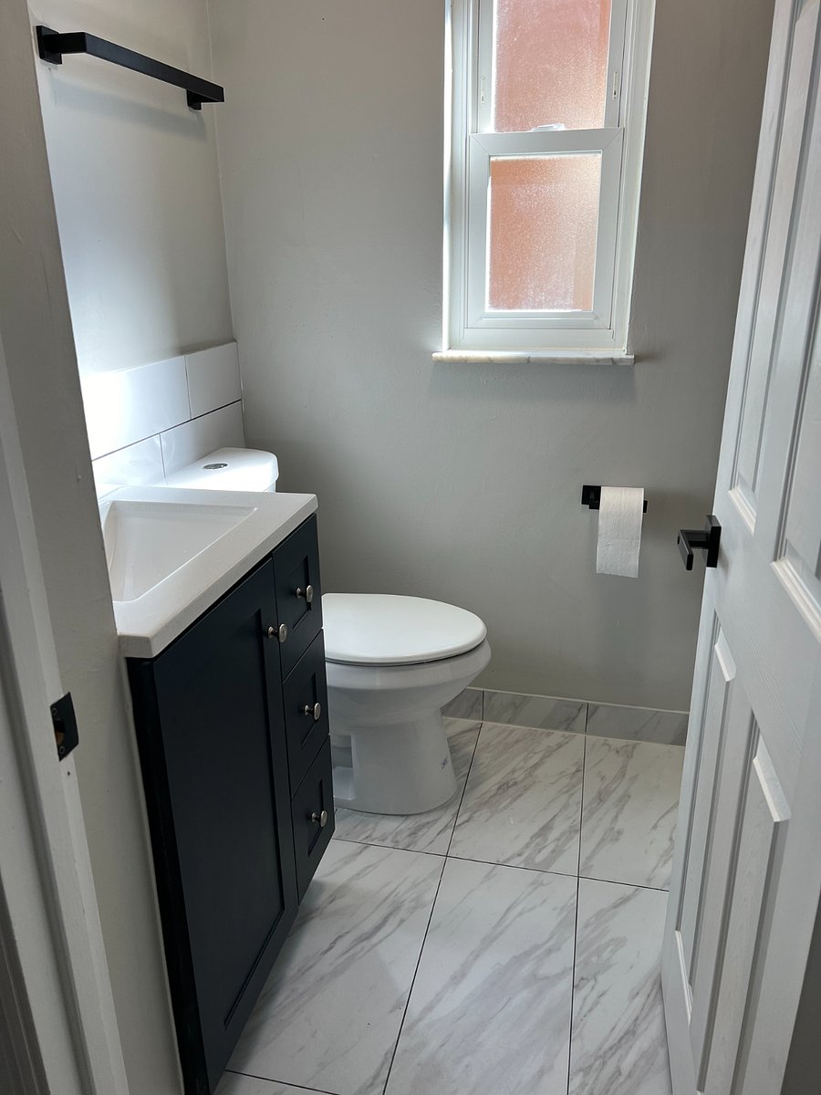 Bath has tile floor and back splash and tile shower. TP, hand soap, and hand lotion included.