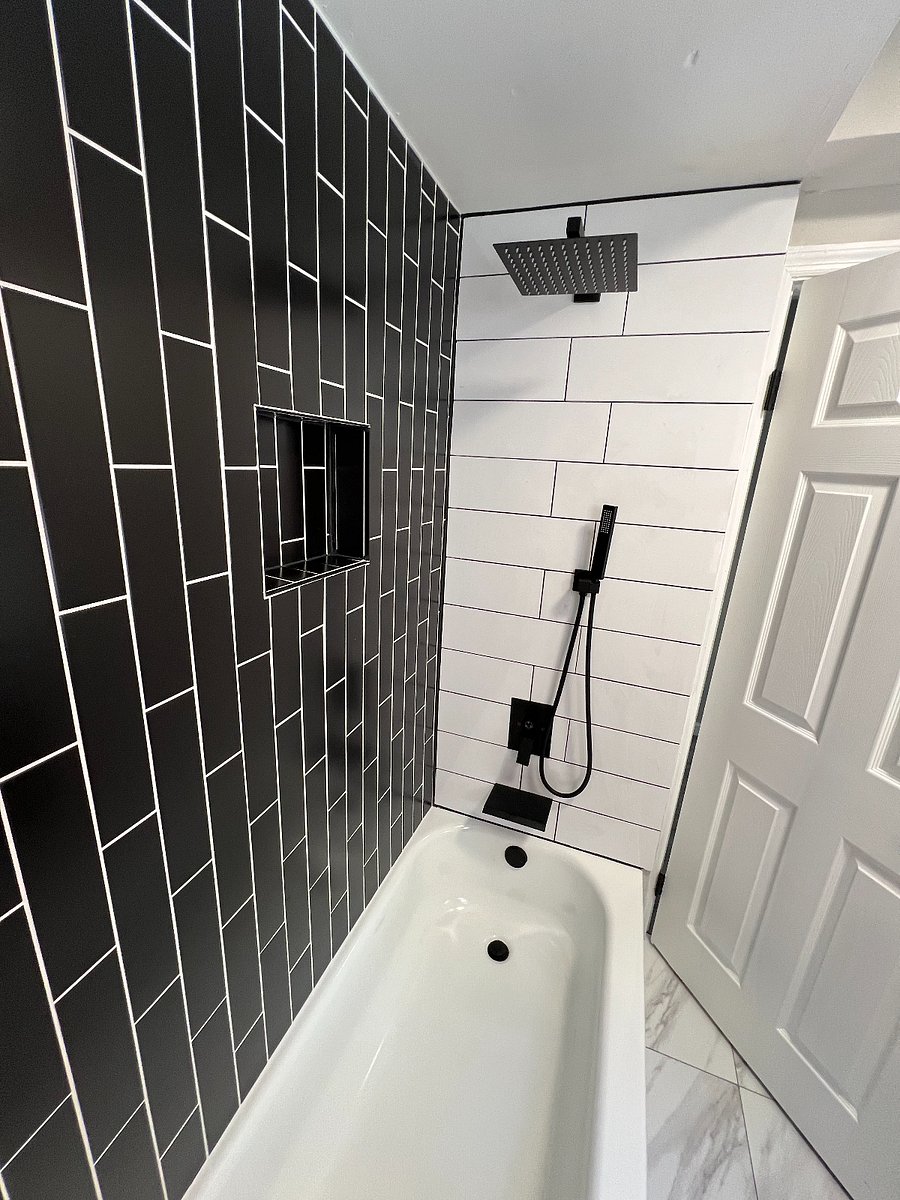 Rain shower with hand wand and smooth flow faucet along with in-shower wall nook for shampoo etc.